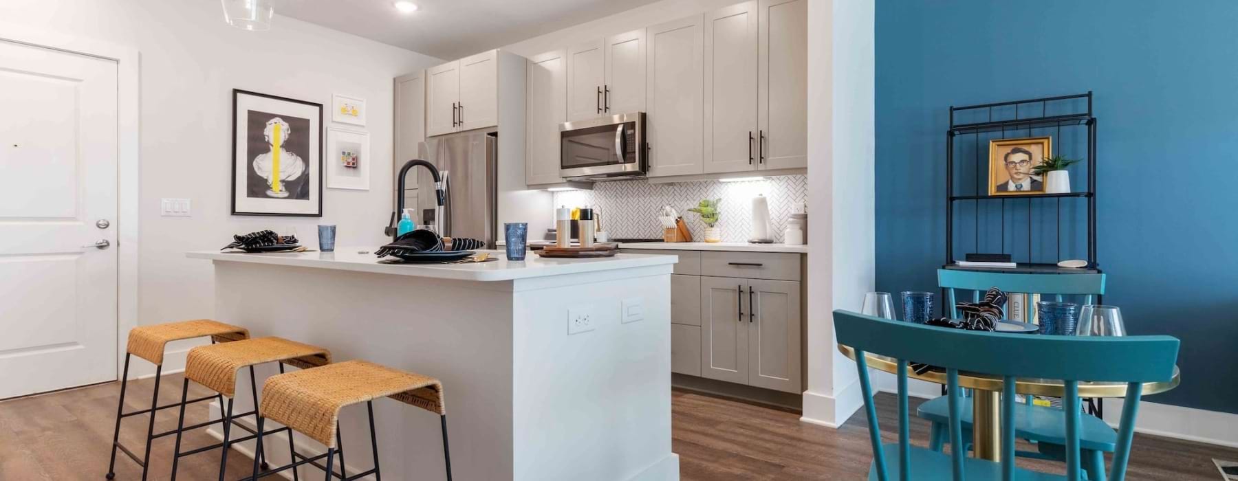 a kitchen with a connected island and bar area