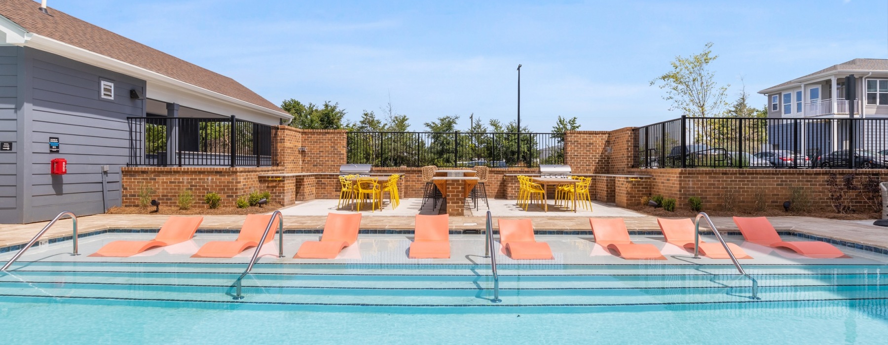 pool showing reclining seating and nearness to property buildings
