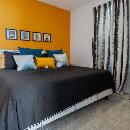 a bedroom with a bed and a chair