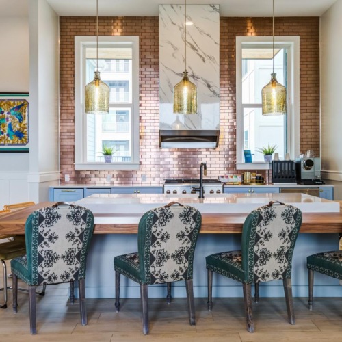 a kitchen with a bar and chairs